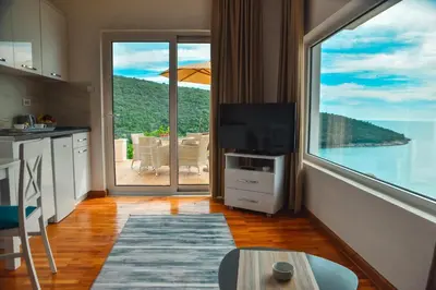 a kitchen with a large window with a view of the ocean at Apartments Blue Heaven in Ulcinj