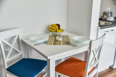 a small kitchen with a table with a bowl of bananas at Apartments Blue Heaven in Ulcinj