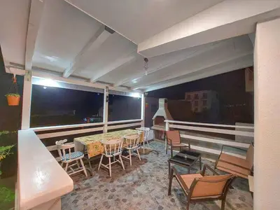 a room with a table and chairs and a balcony at Apartments Marina in Utjeha