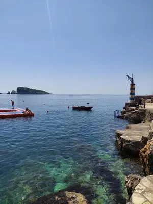 a group of people in the water at a beach at Apartments Marina in Utjeha