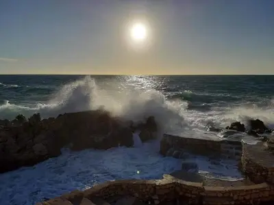 a wave crashing on the rocks in the ocean at Apartments Marina in Utjeha