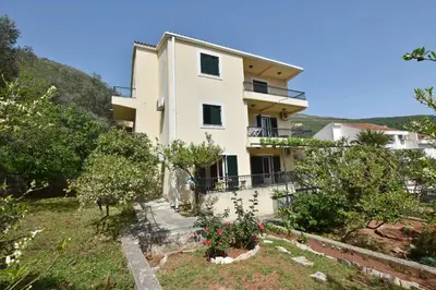 a house on the side of a hill at Apartments and Rooms Iva in Petrovac na Moru