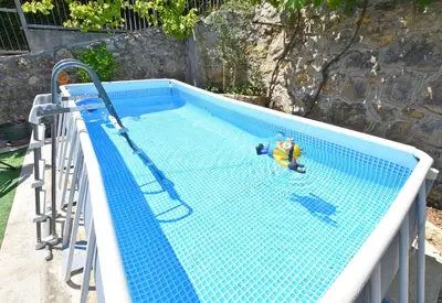 a swimming pool with a toy in the middle at Apartments Siljak in Petrovac na Moru