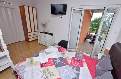 a living room with a table with a quilt on it at Apartments Siljak in Petrovac na Moru