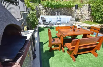 a patio with a wooden table and chairs at Apartments Siljak in Petrovac na Moru