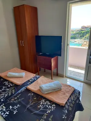 a bedroom with two beds and a flat screen tv at Cosy Apartment in Ulcinj with Sea View - 40 m² in Ulcinj
