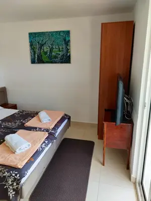 a bedroom with a bed and a tv and a table at Cosy Apartment in Ulcinj with Sea View - 40 m² in Ulcinj