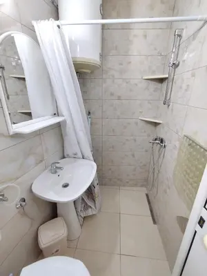 a bathroom with a sink and a toilet and a shower at Cosy Apartment in Ulcinj with Sea View - 40 m² in Ulcinj