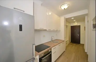 a kitchen with white cabinets and a sink at Langust - free parking in Sveti Stefan