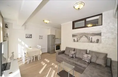 a living room with a couch and a table at Langust - free parking in Sveti Stefan