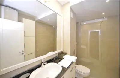 a bathroom with a sink and a toilet and a mirror at Langust - free parking in Sveti Stefan