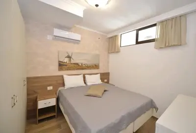 a bedroom with a bed and a windmill at Langust - free parking in Sveti Stefan