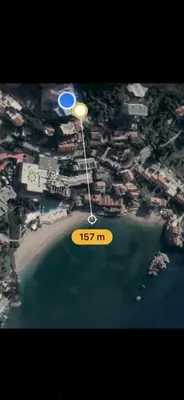 a yellow frisbee is flying over a beach at Langust - free parking in Sveti Stefan
