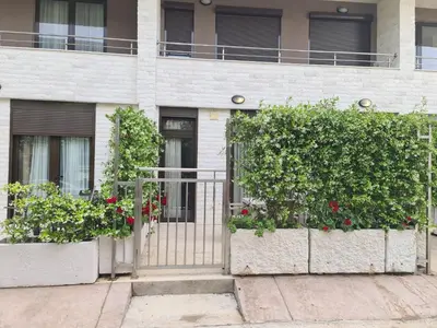 a gate in front of a building with flowers at Langust - free parking in Sveti Stefan