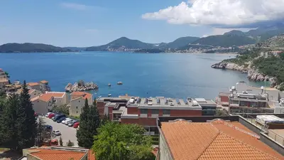 a view of a large body of water with buildings at Langust - free parking in Sveti Stefan