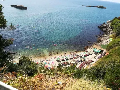 a beach with a crowd of people in the water at Modern Studio with Sea View - Ulcinj - 25 m² - Balcony in Ulcinj