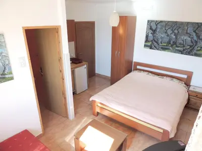 a small bedroom with a bed and a table at Modern Studio with Sea View - Ulcinj - 25 m² - Balcony in Ulcinj