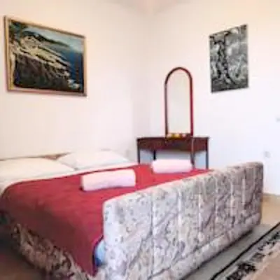 a bedroom with a bed with a red blanket at Sea View Apartment - Ulcinj - 40 sqm in Ulcinj