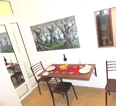 a dining room with a table and a painting on the wall at Sea View Apartment - Ulcinj - 40 sqm in Ulcinj