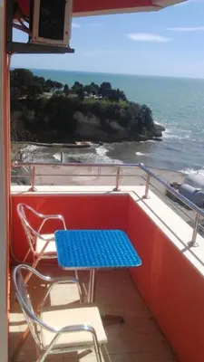 a blue table and chairs on a balcony with the ocean at Sea View Apartment - Ulcinj - 40 sqm in Ulcinj