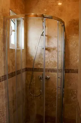 a shower with a glass door in a bathroom at B&B Lovac in Ulcinj