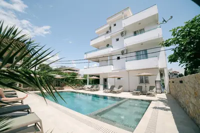 a building with a swimming pool in front of a building at B&B Lovac in Ulcinj