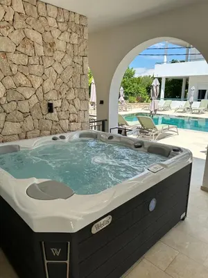 a hot tub in a house with a stone wall at B&B Lovac in Ulcinj