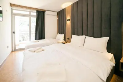 a hotel room with two beds and a window at Hotel Dajti in Ulcinj