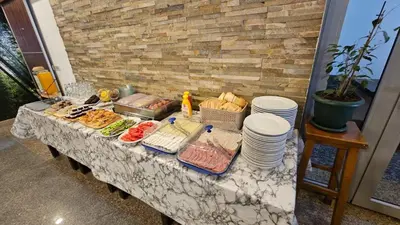 a buffet table with food and plates on it at Hotel Dajti in Ulcinj