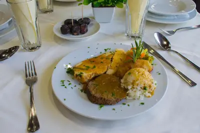 a white plate of food on a white table at Hotel Dajti in Ulcinj