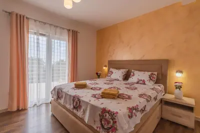a bedroom with a bed and a large window at Villa Sunny Hill in Budva