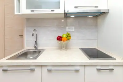 a kitchen with a sink and a bowl of fruit at Apartment Kalle in Kotor