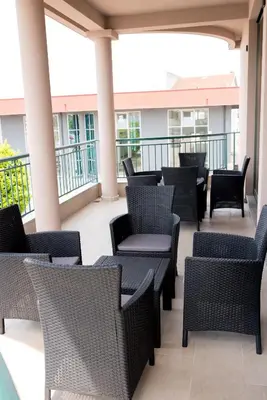 a patio with chairs and tables on a balcony at IPN APARTMENTs in Podgorica