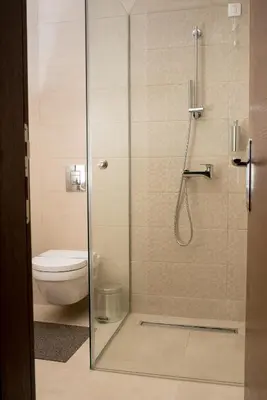 a bathroom with a glass shower with a toilet at IPN APARTMENTs in Podgorica