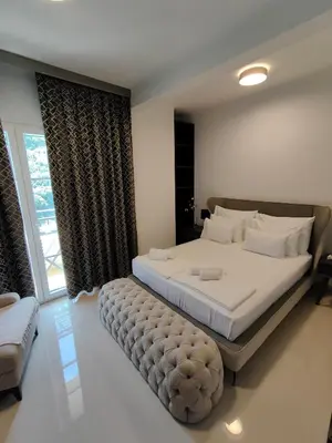 a bedroom with a large bed with a large window at Regina del Mare in Bar