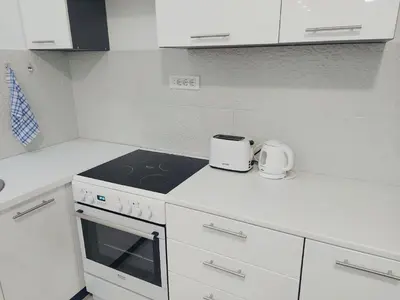 a kitchen with a stove top oven next to a counter at Apartman Mona in Podgorica