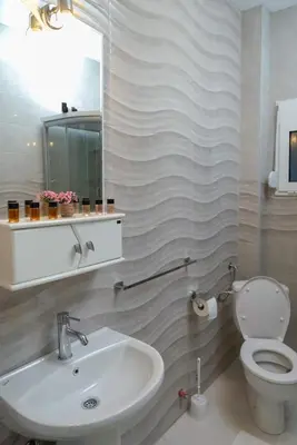 a bathroom with a sink and a toilet and a mirror at Apartman Mona in Podgorica