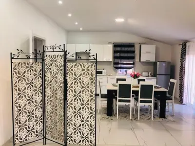 a kitchen with a table and chairs in a room at Apartman Mona in Podgorica