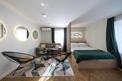 a bedroom with a bed and a table and chairs at Lux - Apartment BCN in Budva