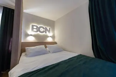 a bedroom with a bed with a sign on the wall at Lux - Apartment BCN in Budva