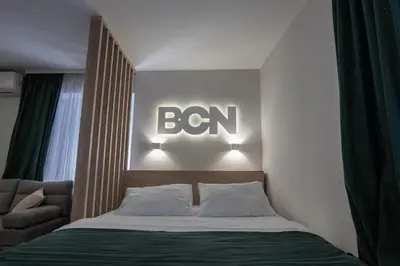 a bedroom with a bed with a sign on the wall at Lux - Apartment BCN in Budva
