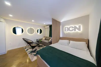 a bedroom with a bed with a sign on the wall at Lux - Apartment BCN in Budva