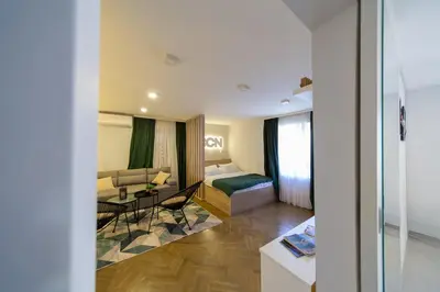 a hotel room with a bed and a living room at Lux - Apartment BCN in Budva