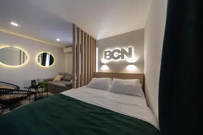 a bedroom with a bed with aben sign on the wall at Lux - Apartment BCN in Budva