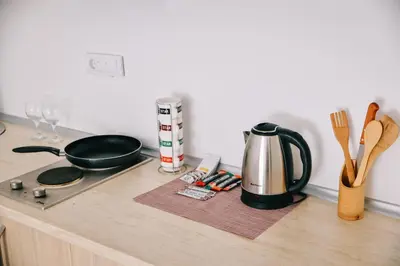 a kitchen counter with a stove and a tea kettle at Riva Luxury in Ulcinj