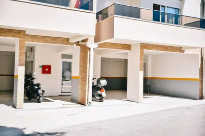 a building with two motorcycles parked inside of it at Riva Luxury in Ulcinj