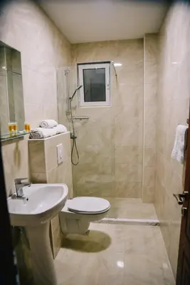 a bathroom with a sink and a toilet and a shower at Riva Luxury in Ulcinj
