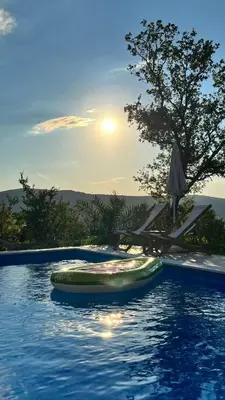 a swimming pool with a raft in the water at Guesthouse P&A in Budva