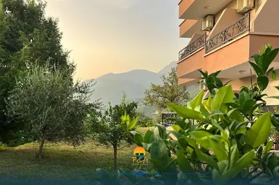 a building with a view of a mountain at Guesthouse P&A in Budva