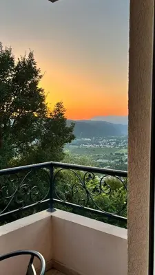 a view of a sunset from a balcony at Guesthouse P&A in Budva